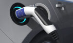 Charging,Plug,In,An,Electric,Car,With,Flag,Of,The