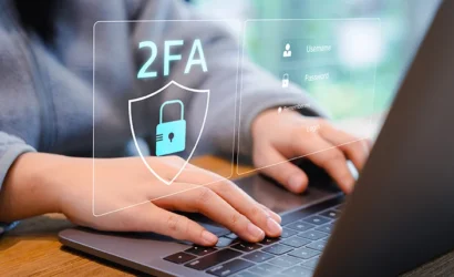 Two-Factor Authentication for Cyber Security. Person using a laptop with a digital screen displaying a shield icon and 2FA representing two-factor authentication and enhanced cyber security measures